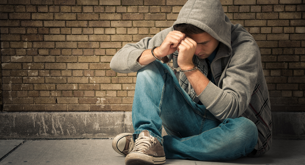 teenage boy in handcuffs